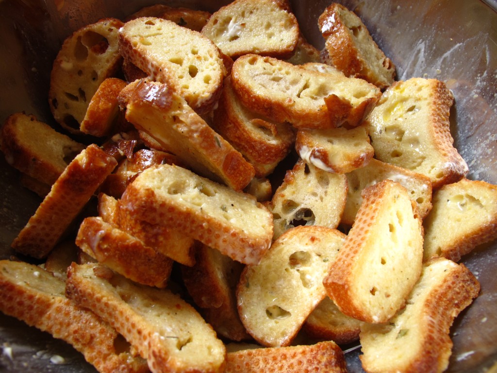 The baguette slices soaking in a mix of milk, egg, salt, pepper and dried herbs.